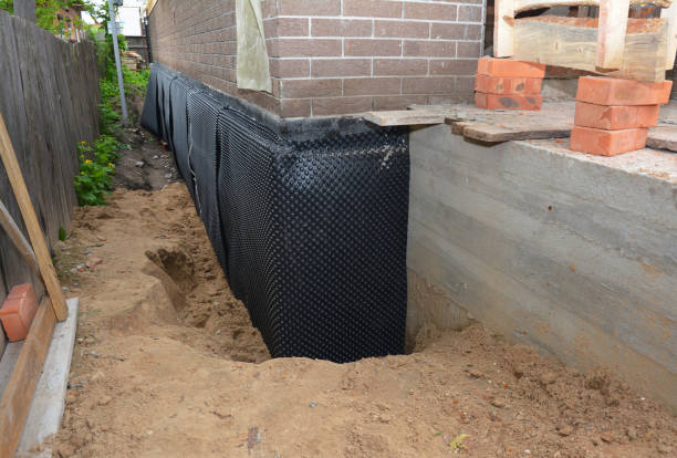 SJ Waterproofing Pros technician performing targeted Wet Basement Repair assessment in Arcanum, OH